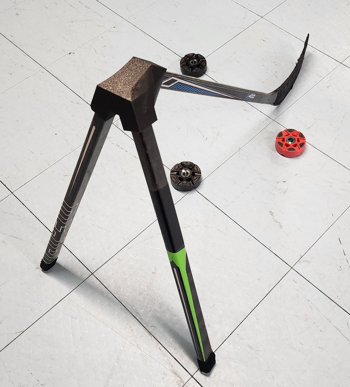 The Training Tripod, a hockey training aid that holds three stick shafts in a tripod configuration